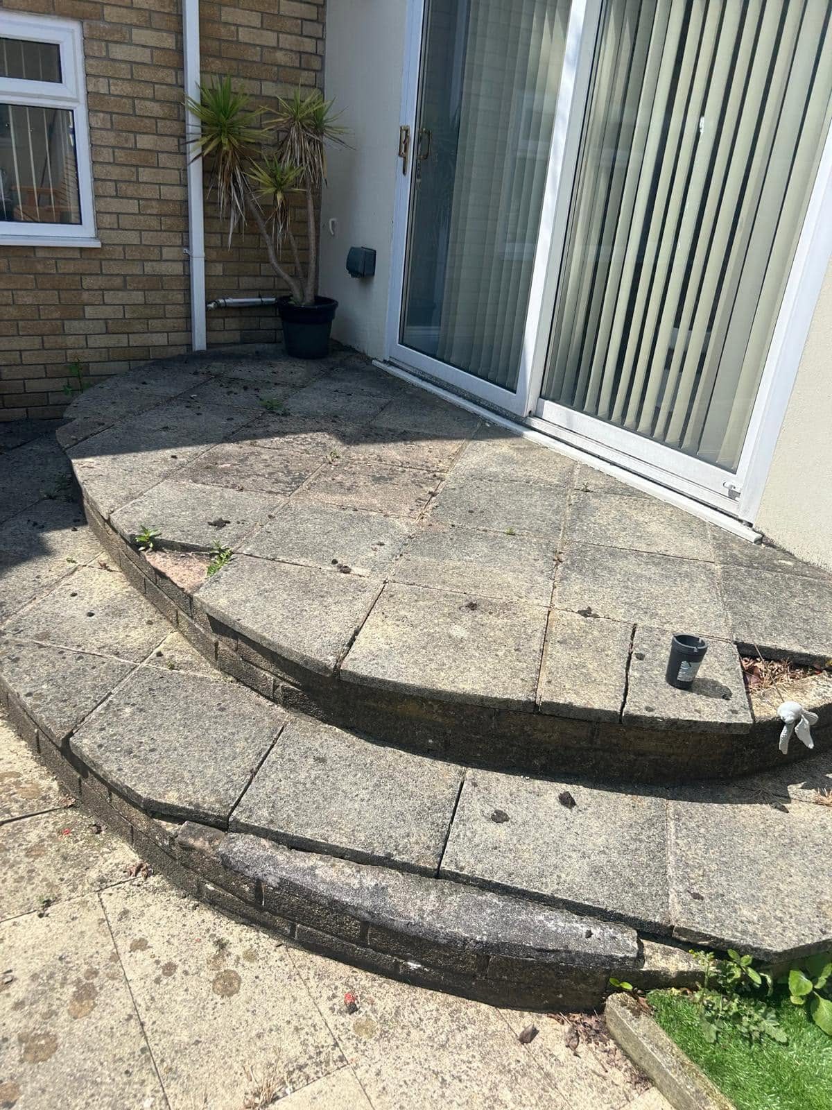Old cracked concrete patio slabs and steps before replacement