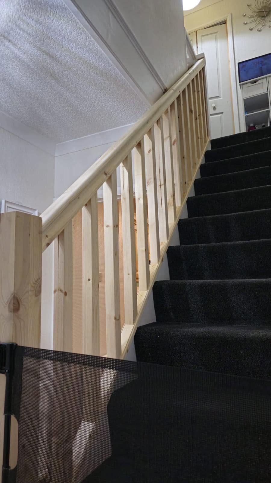 New timber staircase handrail and spindles installed in a home stairwell