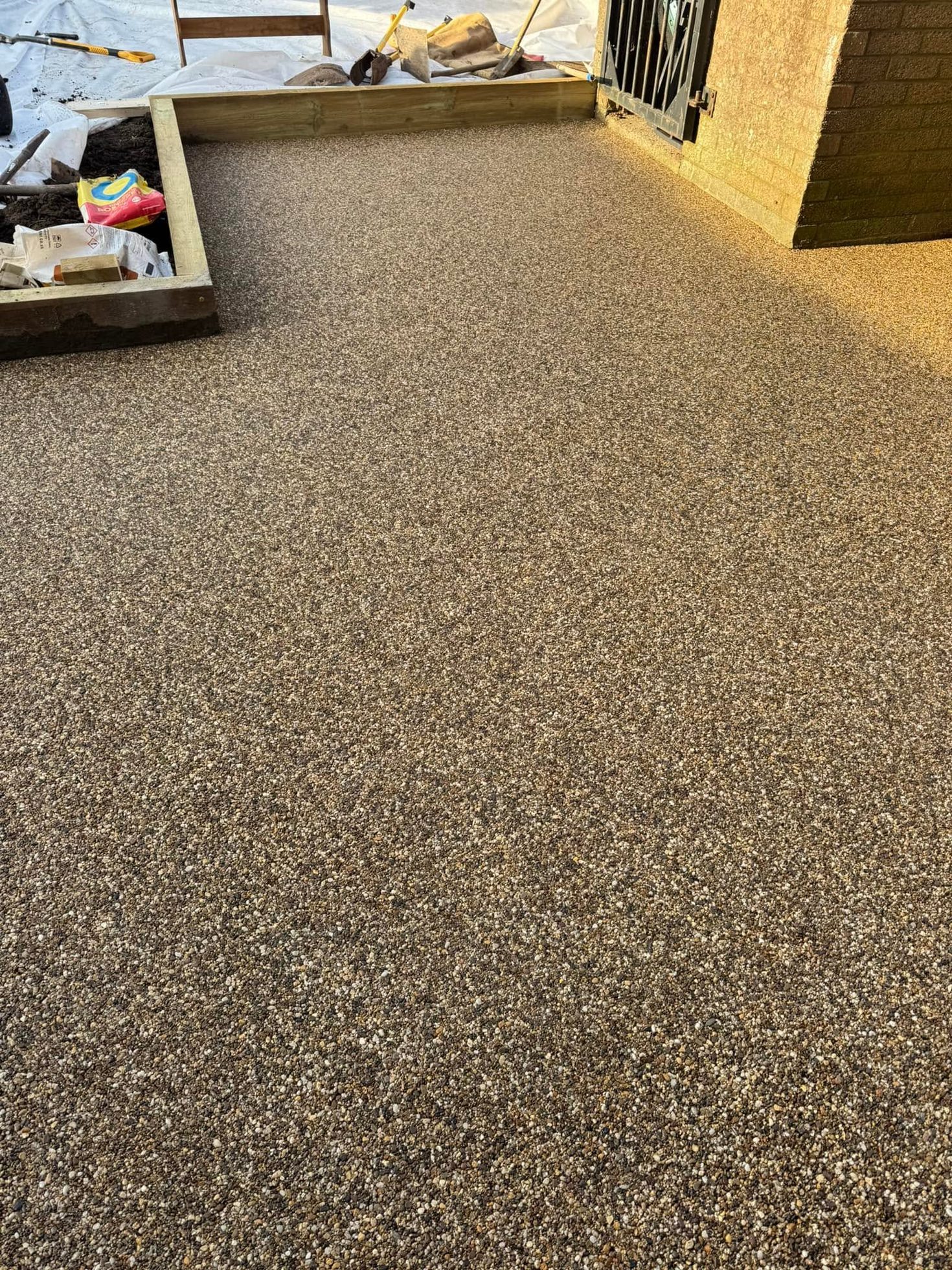 Smooth resin bound gravel surface laid over prepared base