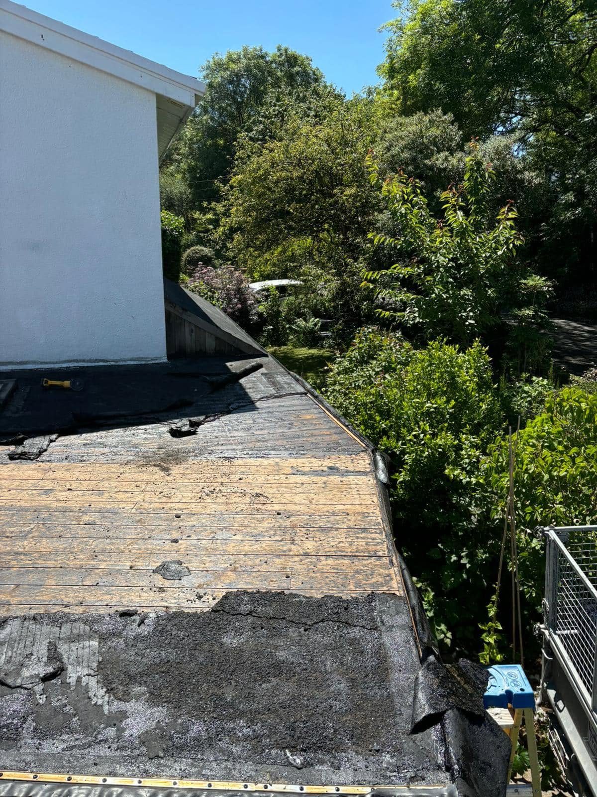 Failed felt flat roof stripped back to timber deck before replacement