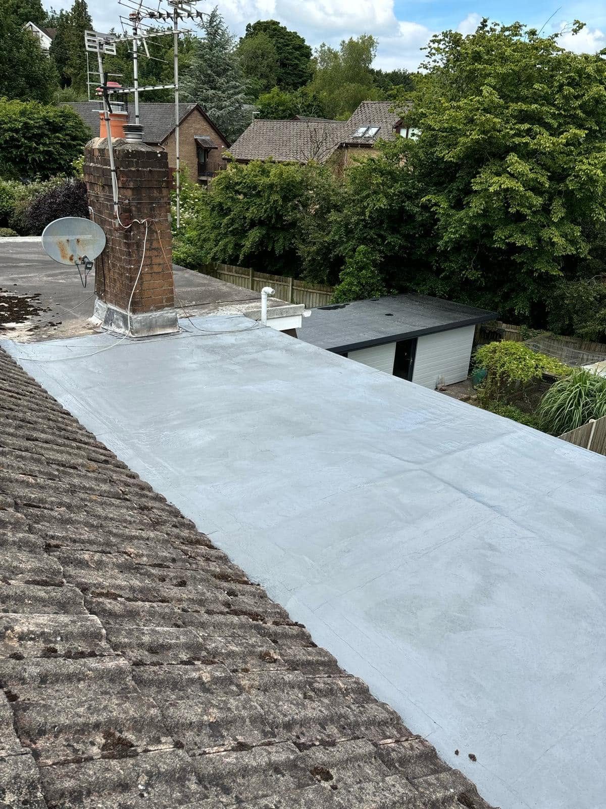 Flat roof covering renewed around an existing chimney stack on a South Wales home