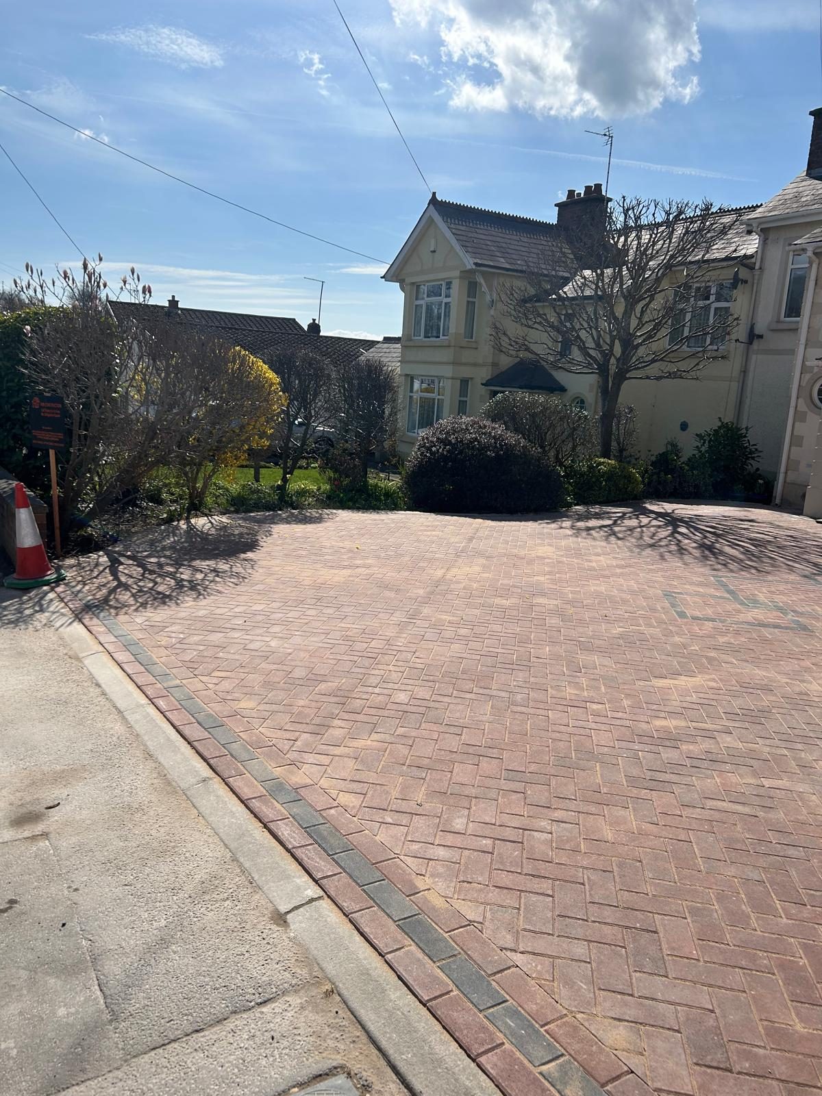 Red herringbone block paving driveway laid outside a residential street in South Wales