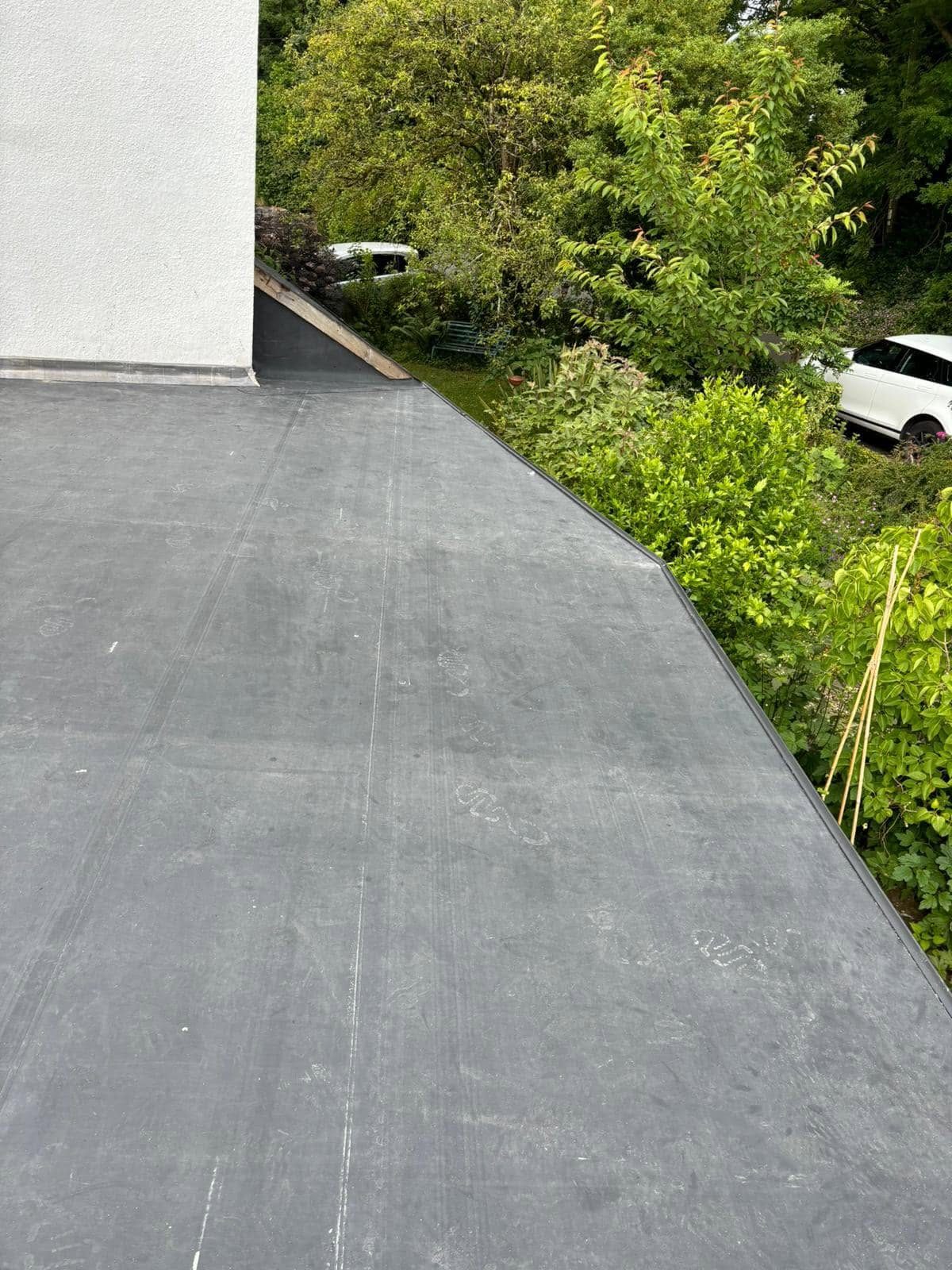 New rubber flat roof membrane laid and sealed at the edges after replacement